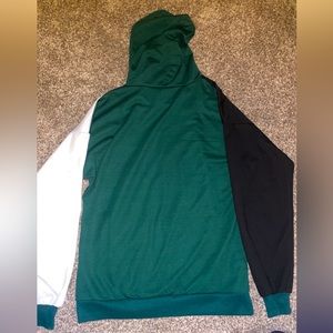 A small white/green/black mismatch hoodie. 97% polyester 3% spandex.